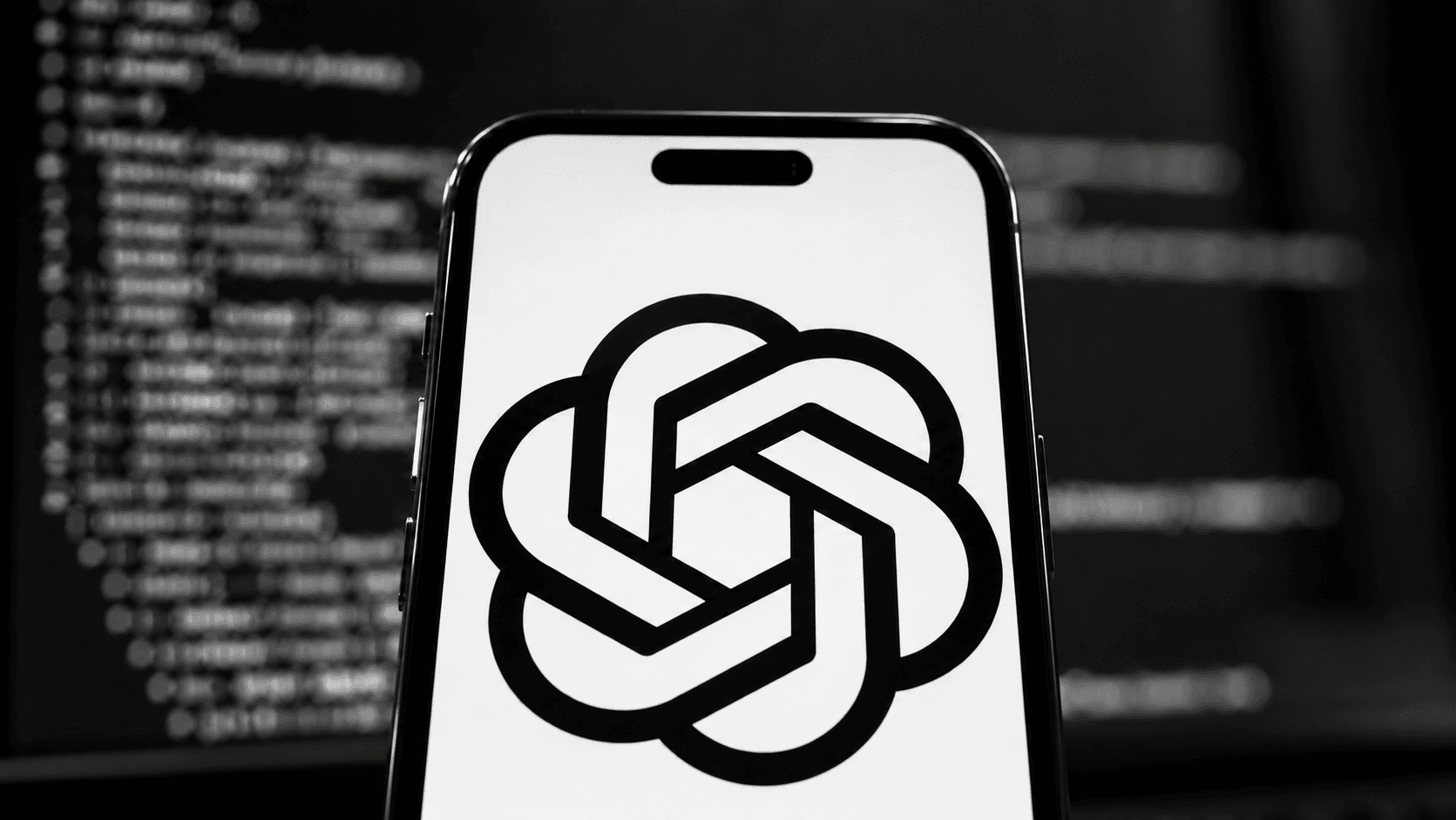 Smartphone with the ChatGPT logo on screen in front of code